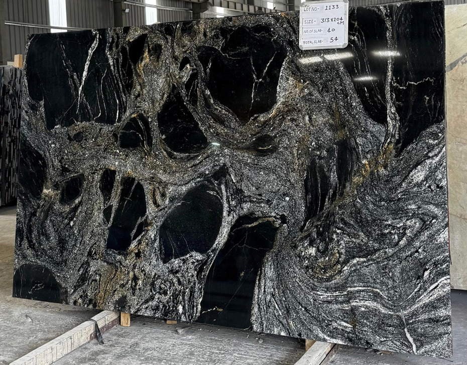 Large rectangular slab of polished natural stone with a striking pattern of deep black swirls interspersed with shimmering silver and gold veins